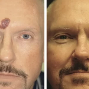 a close up of a man who is smiling and looking at the camera